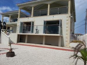 a large white house with a large balcony at Mari Sol in Saint Philip