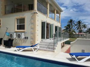 a villa with a swimming pool and a house at Mari Sol in Saint Philip