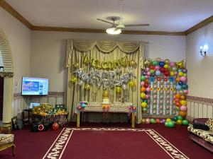 a party with balloons and a sign that says congratulations at Private Cottage in Sharjah