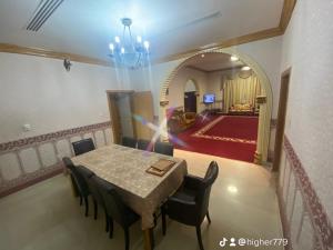 a dining room with a table and some chairs at Private Cottage in Sharjah