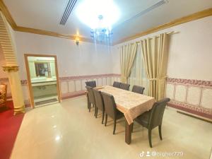 a dining room with a table and chairs at Private Cottage in Sharjah