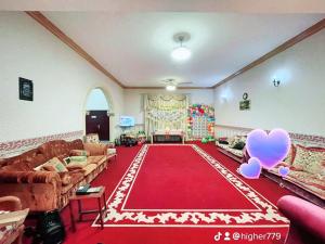 a living room with a red carpet and two pink hearts at Private Cottage in Sharjah