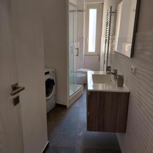 uma casa de banho com um lavatório e uma máquina de lavar roupa em SEA COTTAGE em Savona