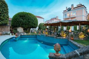 a swimming pool in the yard of a house at Boutique Hotel Don Alfonso 1890 in SantʼAgata sui Due Golfi