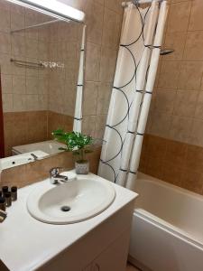 a bathroom with a sink and a tub and a shower at Flora Hotel Apartment 103 in Borovets