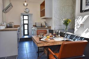 a kitchen with a table with food on it at Engine House apartment - a Unique Holiday Home for 2 in Marazion