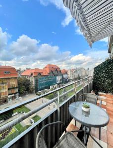 a balcony with a table and a view of a city at City Center View Studio Apartment 1 in Timişoara