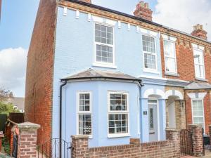 a blue house with a brick building at The House in Gorleston in Great Yarmouth
