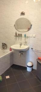 a bathroom with a sink and a mirror at Apartmány Maňová 