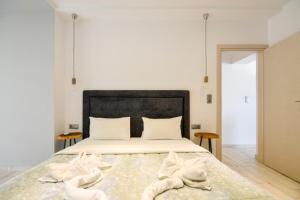 a bedroom with a bed with towels on it at Zinozis Beach Apartments in Vourvourou