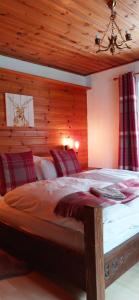 a bedroom with a large bed with a wooden ceiling at Gasthof Zum Lugauer in Radmer an der Hasel