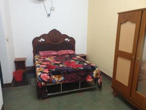 a bedroom with a bed with a quilt on it at Villa Pointe Aux Piments in Pamplemousses Village