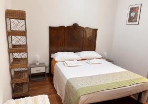 a bedroom with a bed with a wooden headboard at Roma Basento in Rome