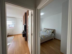 a bedroom with a bed and an open door at Stan na dan Lorena in Sarajevo