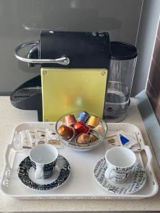 a tray with two cups and plates on a table at Villa 61 Sea and Sunset View in Dhërmi