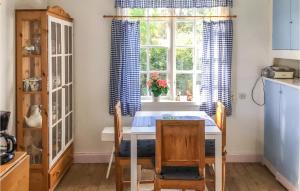 a kitchen with a table and chairs and a window at Lovely Home In rsundsbro With Wifi in Örsundsbro