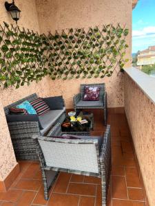 a patio with a couch and chairs and a table at Casa Moch in Francavilla al Mare