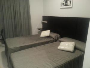 מיטה או מיטות בחדר ב-Casa de Larios