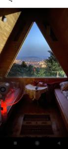 a room with a window with a view of a city at Bungalovi Lana in Sarajevo