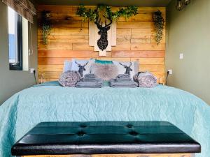 a bedroom with a bed with a wooden wall at Coral Cabins in Dunvegan