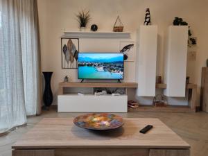 - un salon avec une télévision et une table dans l'établissement GIULIA'S HOUSE - Natura & Avventura, à Castel di Sangro