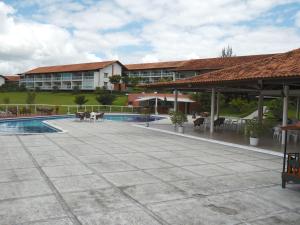 a resort with a swimming pool and a building at Flat 404 Villa Hipica in Gravatá