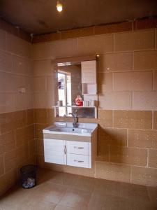 a bathroom with a sink and a mirror at Desert Mars Camp & Tours in Wadi Rum