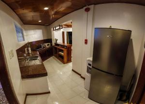 a kitchen with a stainless steel refrigerator and a sink at Twin House Villa in Coron