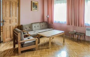 a living room with a couch and a table at Two-Bedroom Holiday Home In Osno Lubuskie in Ośno Lubuskie