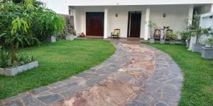 a walkway in the yard of a house at Ceylonray Travels and Holidays in Hikkaduwa