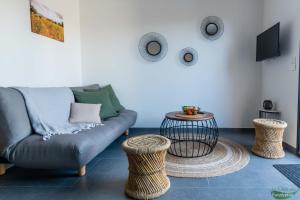 a living room with a couch and a table at Le Clos des Eucalyptus in Plan-de-la-Tour