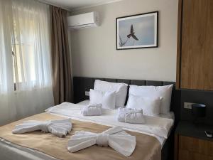 a hotel room with a bed with bows on it at Apartman 207 in Zlatibor