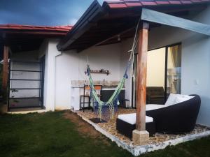a porch with a hammock in a house at Villa Namaste, Cabaña Namaste 1 in Curití