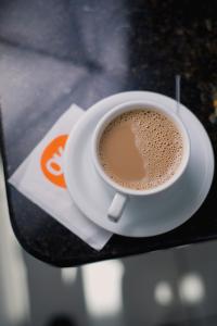 a cup of coffee sitting on a table at OK Inn Hotel in Tubarão