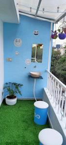 a balcony with a sink on a blue wall at Casa - By Great Impressions in Pune