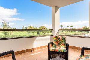 a balcony with two chairs and two windows at Modern apartment in residential complex with pools in Costa de Antigua