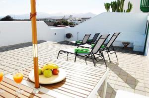 a plate of fruit on a table on a balcony at Typical Canarian house with fabulous sea views in Tías