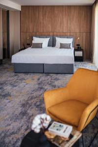 a hotel room with a bed and a couch at City Hotel Dubrovnik in Dubrovnik