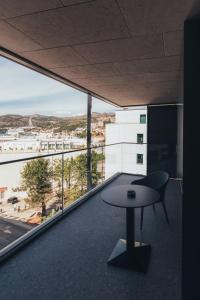 a balcony with a table and a view of a city at City Hotel Dubrovnik in Dubrovnik