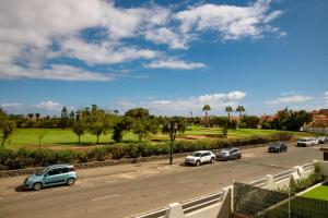a group of cars parked on the side of a road at Modern apartment in residential complex with pools in Costa de Antigua