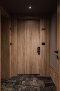 a wooden door in a building with a sign on it at City Hotel Dubrovnik in Dubrovnik
