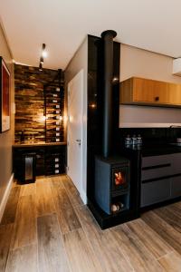 a kitchen with a wood stove in a room at Vista Vigneti Albergo & Vino - Vale dos Vinhedos in Bento Gonçalves