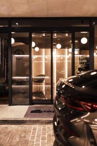 a black car parked in front of a store at City Hotel Dubrovnik in Dubrovnik