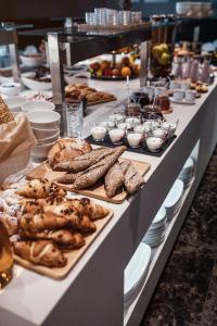 a buffet line with different types of bread and pastries at City Hotel Dubrovnik in Dubrovnik
