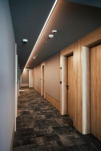 a corridor of an office with a row of doors at City Hotel Dubrovnik in Dubrovnik