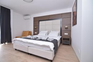 a bedroom with a large white bed in a room at Villa Mystic in Ohrid +63 photos