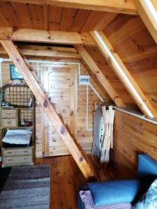 a room in a log cabin with a loft at Domek Jantar in Jantar