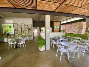 a group of tables and chairs in a building at Biohotel Rio Claro in Doradal