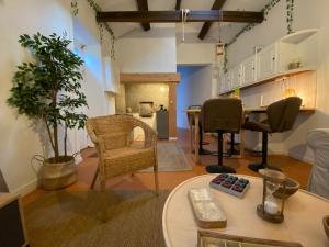 a living room with a table and chairs at Ribeira do Guilherme - Watermill house Botanic Garden in Nordeste