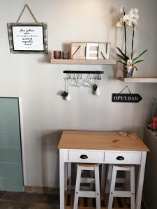 a white desk with two stools in a room at Escapade Normande SPA in Yerville +10 photos